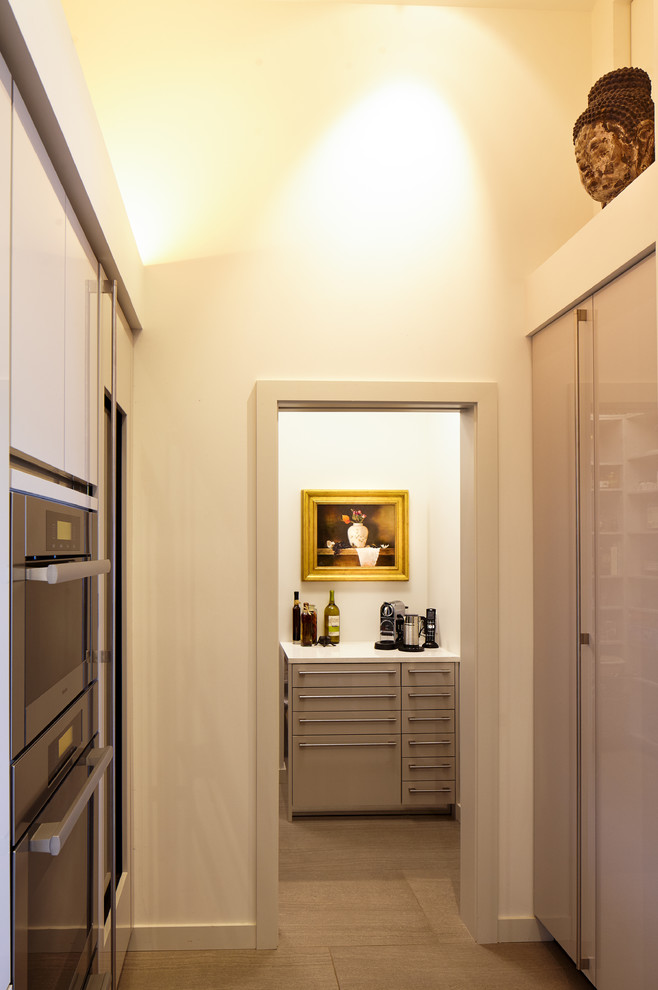 Eat-in kitchen - large transitional gray floor and ceramic tile eat-in kitchen idea in Seattle with quartzite countertops, stainless steel appliances, two islands, an undermount sink, flat-panel cabinets, dark wood cabinets and white countertops