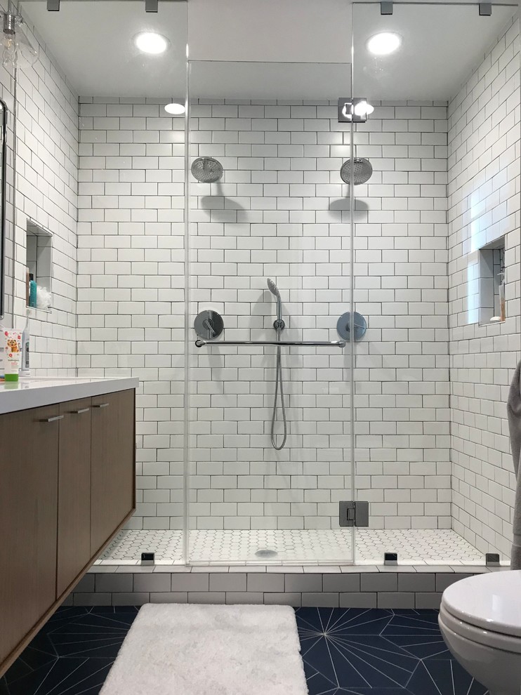 This is an example of a mid-sized country master bathroom in Los Angeles with flat-panel cabinets, brown cabinets, a double shower, a two-piece toilet, white tile, subway tile, white walls, ceramic floors, an undermount sink, quartzite benchtops, blue floor, a sliding shower screen, white benchtops, a double vanity, a floating vanity and a niche.