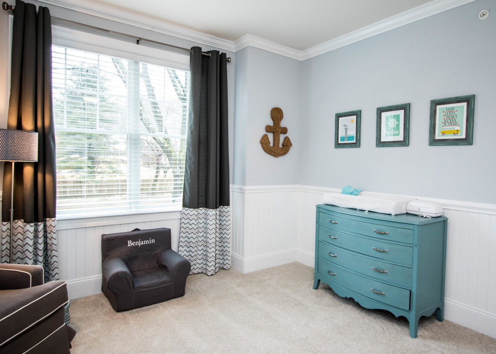 This is an example of a mid-sized transitional nursery for boys in Philadelphia with blue walls and carpet.