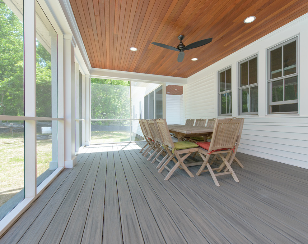 Design ideas for a mid-sized country backyard deck in Baltimore with a roof extension.