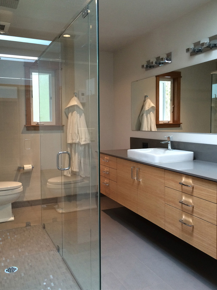Large contemporary 3/4 bathroom in Seattle with flat-panel cabinets, light wood cabinets, a curbless shower, beige walls, porcelain floors, a vessel sink, engineered quartz benchtops, beige floor and a hinged shower door.