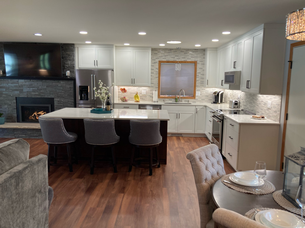 Eat-in kitchen - mid-sized transitional l-shaped eat-in kitchen idea in Other with shaker cabinets, white cabinets, quartz countertops, an island and white countertops