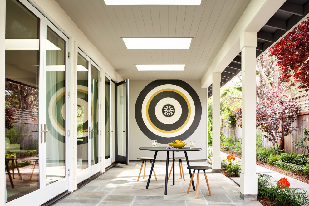 Inspiration for a transitional side yard patio remodel in San Francisco with a roof extension