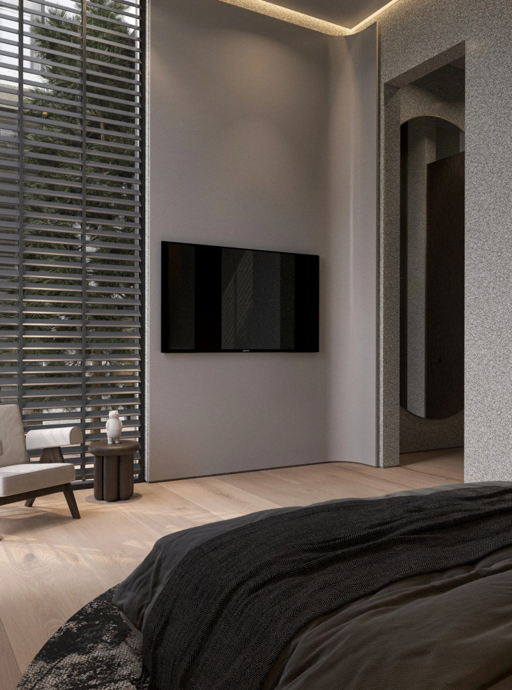 Modelo de habitación de invitados contemporánea de tamaño medio sin chimenea con paredes beige, suelo de madera clara y suelo beige