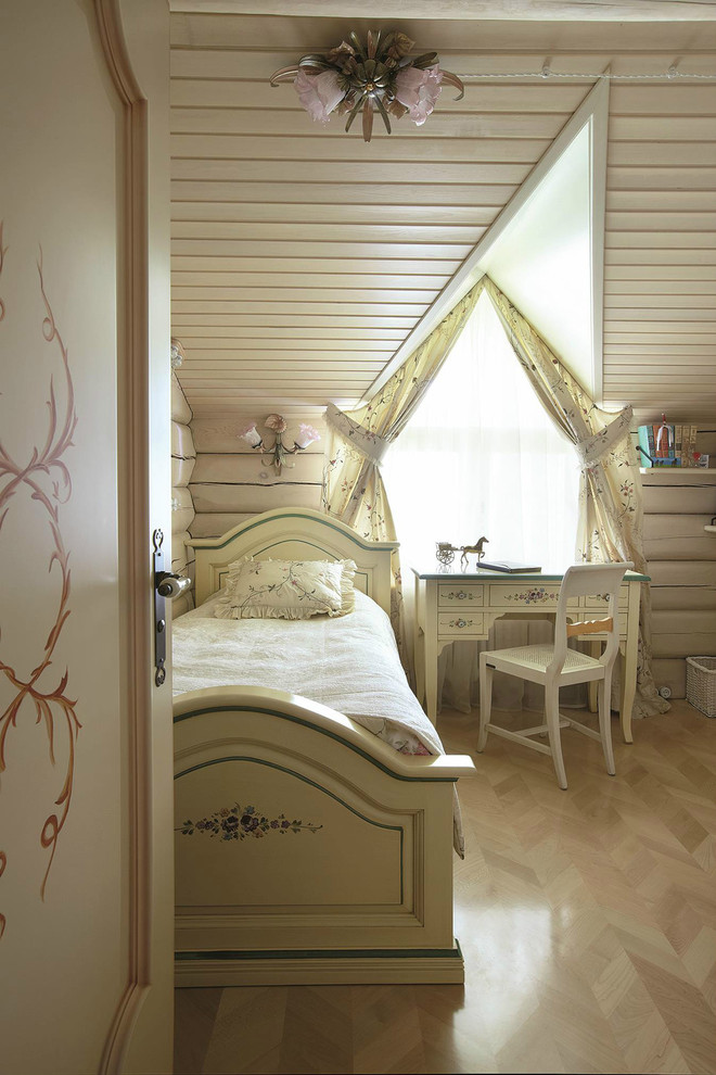 Mid-sized country kids' bedroom in Other with beige walls and light hardwood floors for kids 4-10 years old and girls.