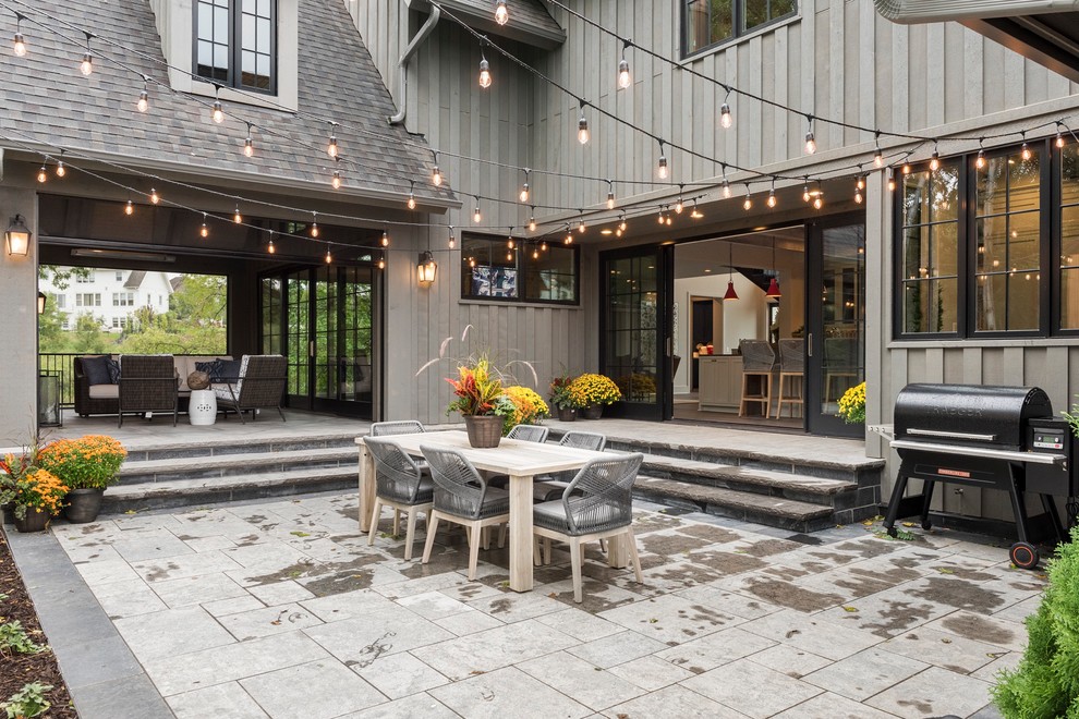 Photo of a mid-sized contemporary courtyard patio in Minneapolis with natural stone pavers.