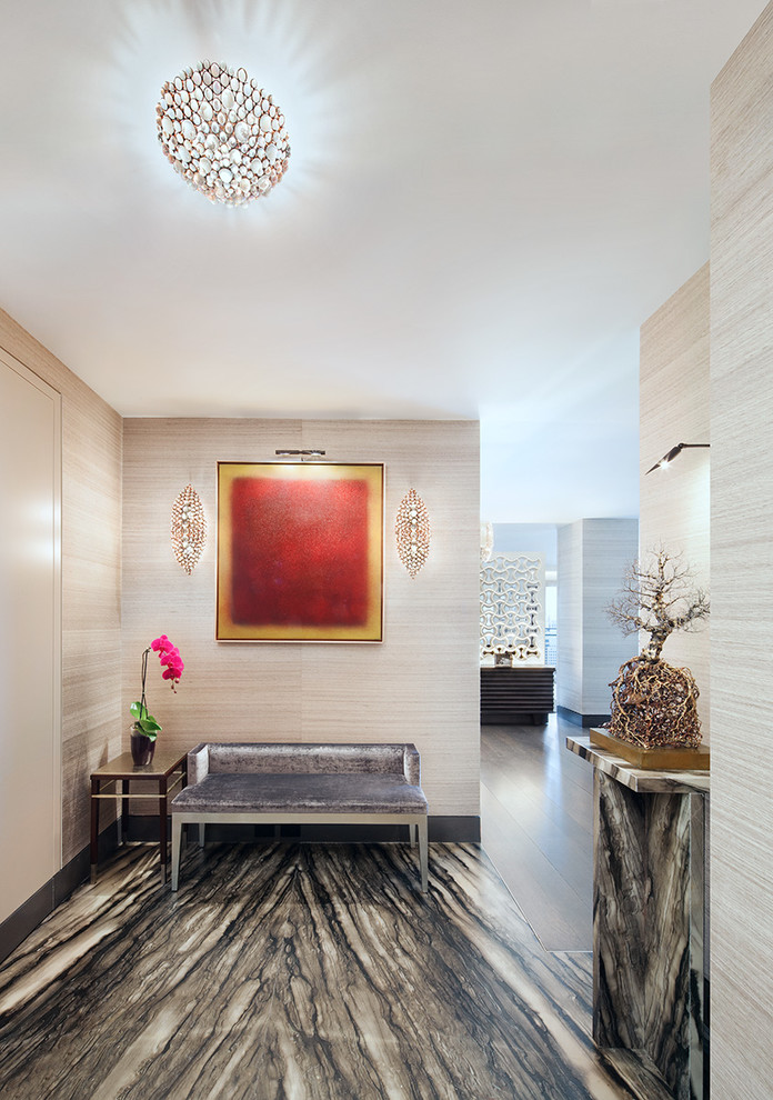 Photo of a contemporary foyer in New York with beige walls and grey floor.