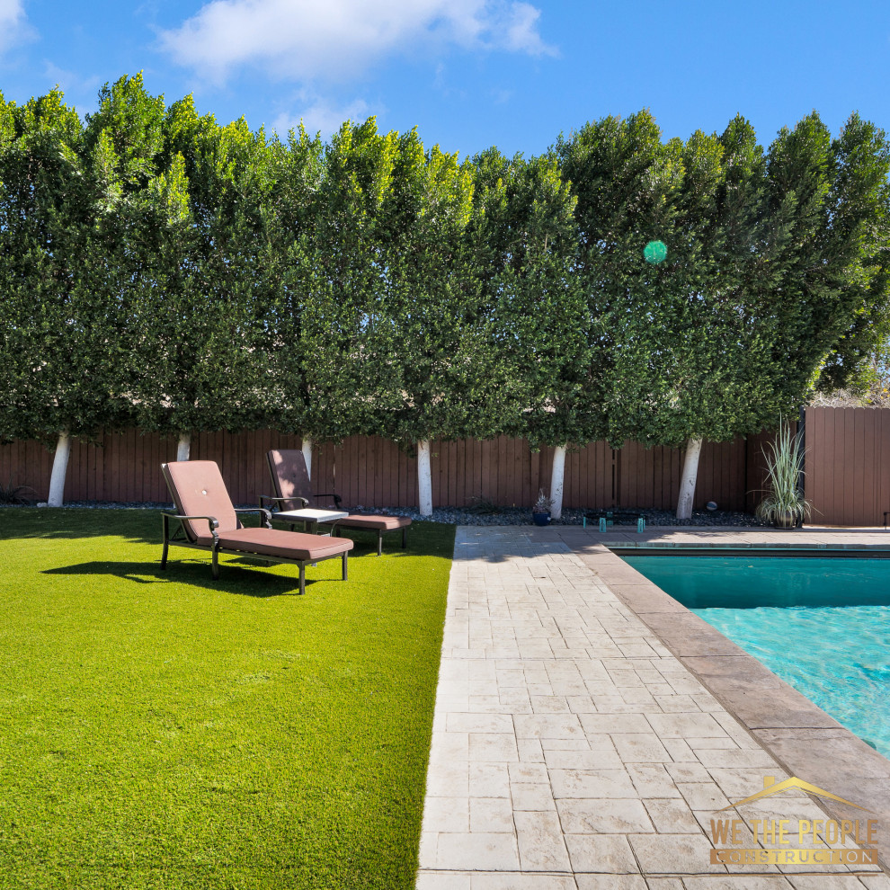 This is an example of a large beach style backyard rectangular lap pool in Los Angeles with with a pool and brick pavers.