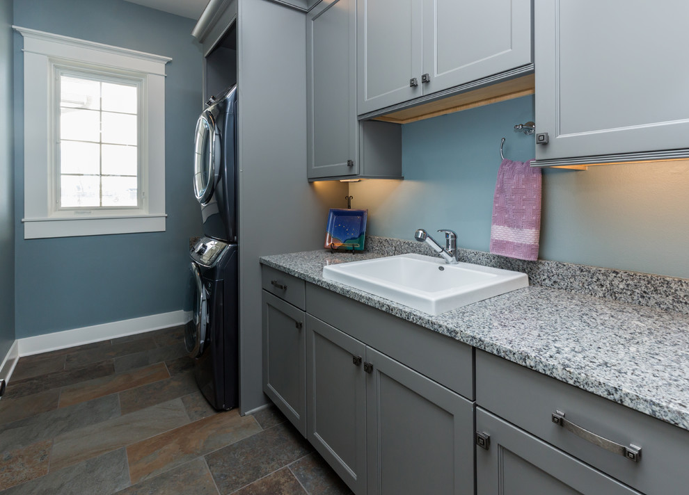 Example of a transitional dedicated laundry room design with gray cabinets