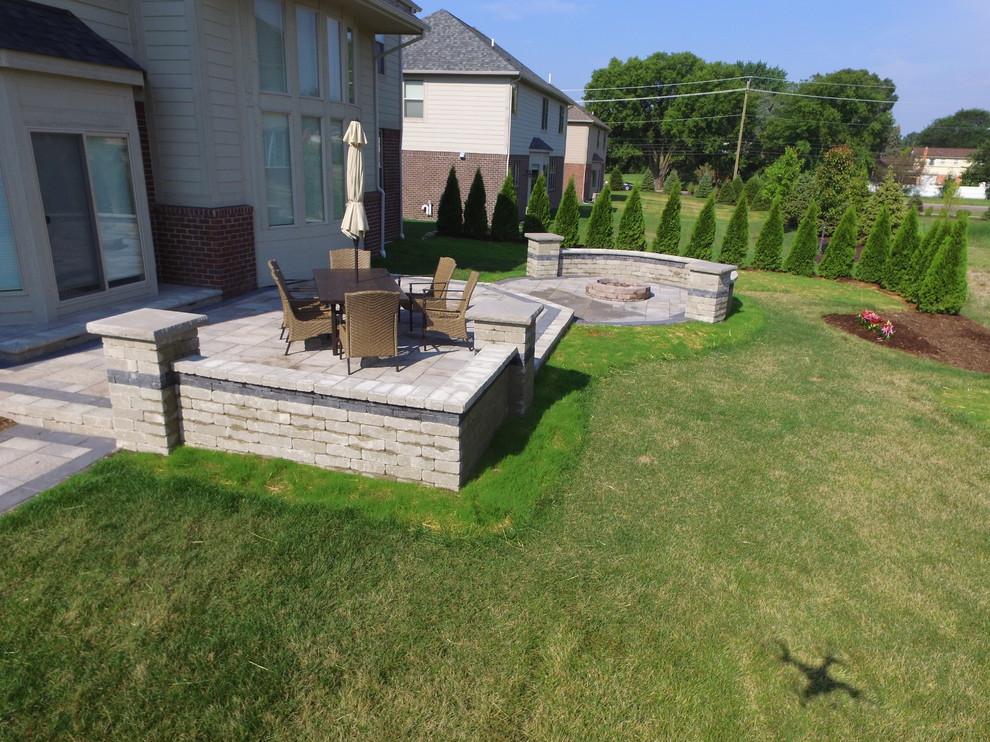 Large backyard patio in Detroit with brick pavers.
