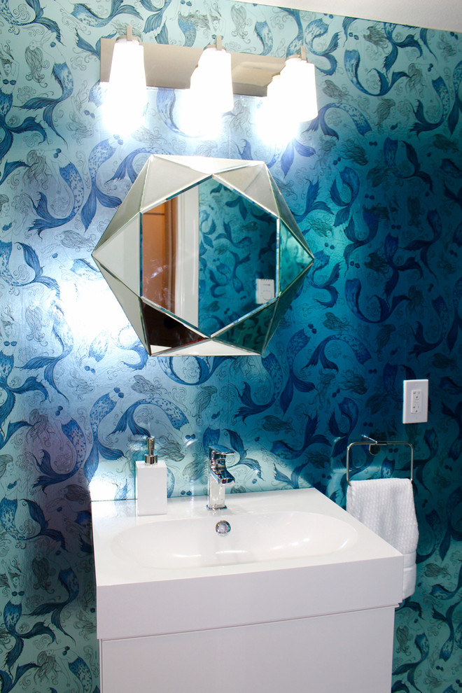 Inspiration for a small eclectic powder room in Vancouver with a wall-mount sink, flat-panel cabinets, white cabinets and blue walls.
