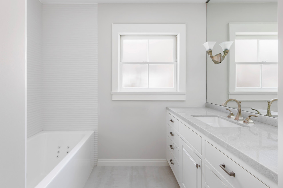 Bathroom - mid-sized contemporary white tile and porcelain tile porcelain tile, gray floor and single-sink bathroom idea in Los Angeles with beaded inset cabinets, white cabinets, a two-piece toilet, white walls, an undermount sink, quartz countertops and white countertops