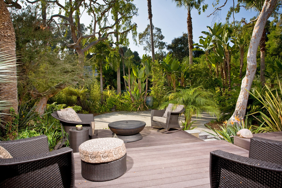 Photo of a large tropical backyard deck in San Diego with no cover.