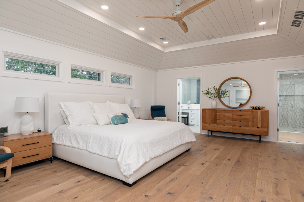 Master bedroom in Atlanta with light hardwood floors and recessed.
