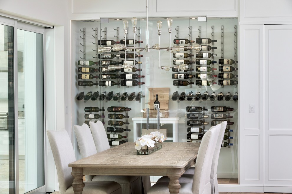 Inspiration for a mid-sized contemporary wine cellar in Miami with cork floors, storage racks and beige floor.
