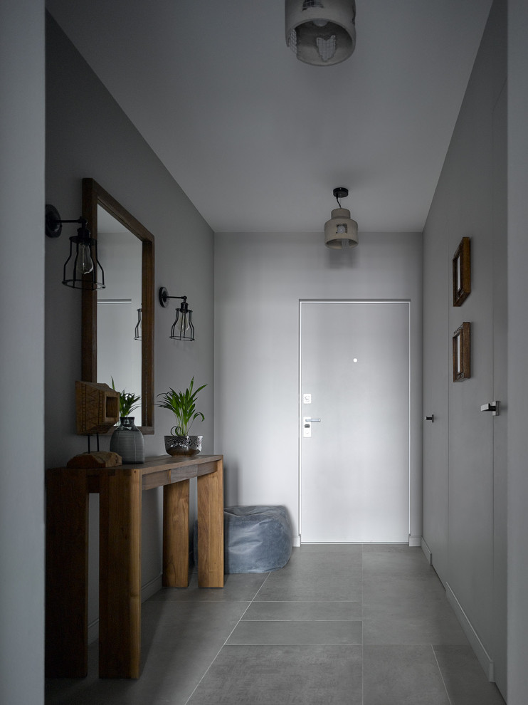 Inspiration for a mid-sized industrial entryway in Moscow with grey walls.
