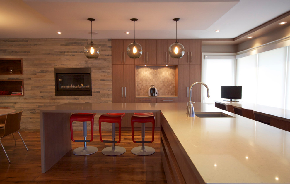 Photo of an expansive contemporary l-shaped wet bar in Toronto with an undermount sink, flat-panel cabinets, brown cabinets, quartz benchtops, beige splashback, ceramic splashback and medium hardwood floors.