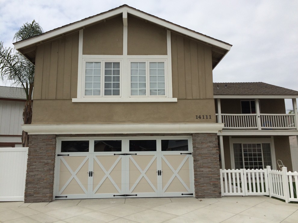 Photo of a large country two-storey stucco beige exterior in Orange County with a gable roof.