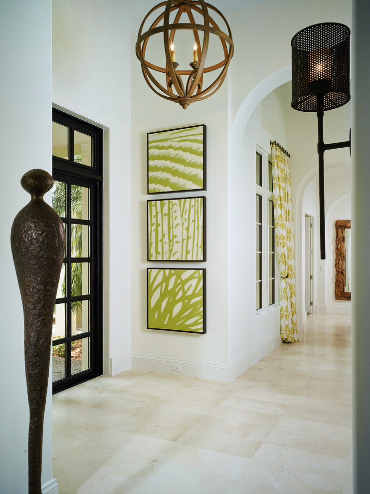 Design ideas for a tropical entryway in Miami with white walls.