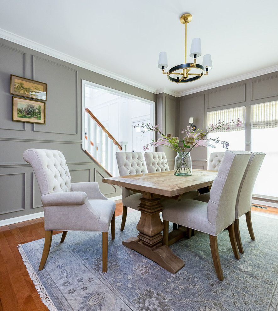 Traditional separate dining room in DC Metro with grey walls, medium hardwood floors and brown floor.