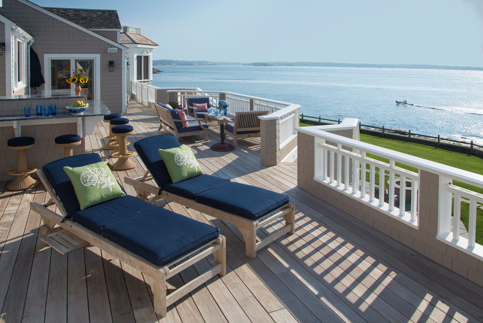 Design ideas for an expansive beach style rooftop and first floor deck in Boston with a pergola.