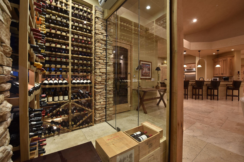 Design ideas for a small mediterranean wine cellar in Phoenix with travertine floors, storage racks and beige floor.
