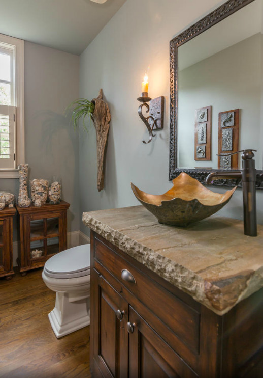 Photo of a mid-sized contemporary powder room in Atlanta with furniture-like cabinets, dark wood cabinets, grey walls, medium hardwood floors and a vessel sink.