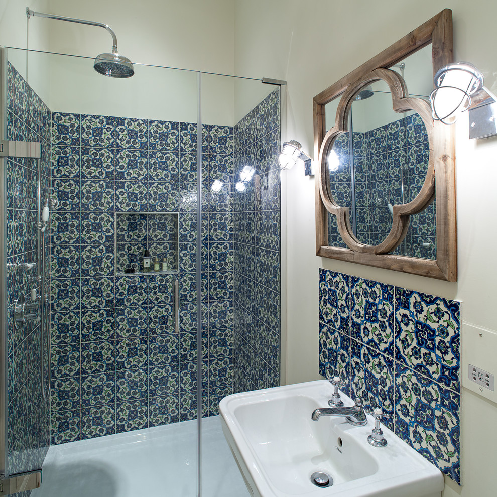 Mid-sized traditional master bathroom in London with a corner shower and blue tile.