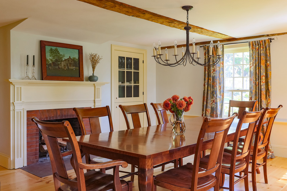 Enclosed dining room - mid-sized cottage light wood floor enclosed dining room idea in Boston with white walls and a standard fireplace
