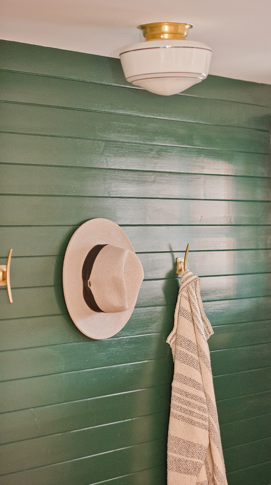 Small transitional light wood floor and brown floor foyer photo with green walls and a black front door