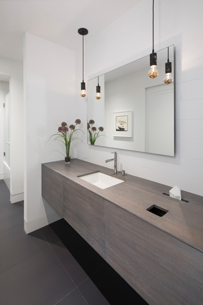 This is an example of a mid-sized contemporary master bathroom in Minneapolis with flat-panel cabinets, distressed cabinets, white walls, porcelain floors, grey floor, white tile, an undermount sink and wood benchtops.