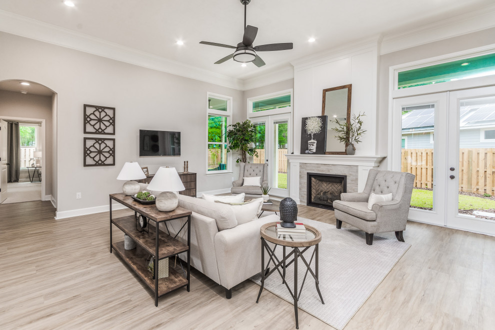 Mid-sized open concept living room in Other with beige walls, vinyl floors, a standard fireplace, a tile fireplace surround, a wall-mounted tv, brown floor and vaulted.