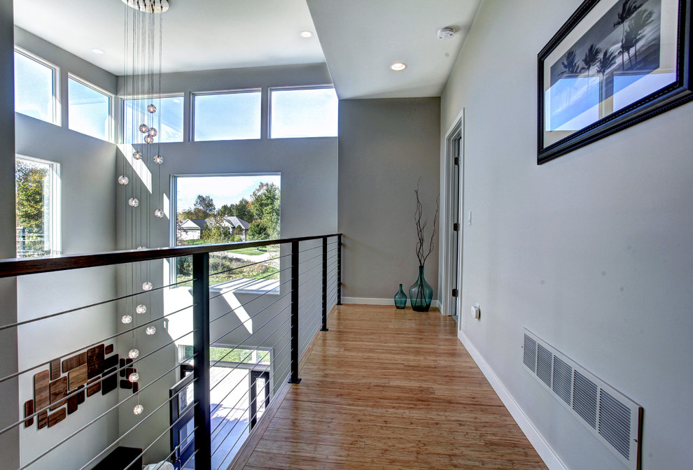 Photo of a mid-sized contemporary hallway in Grand Rapids with grey walls and bamboo floors.
