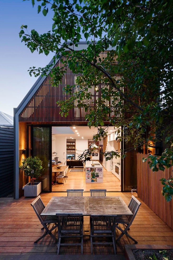 Photo of a small contemporary two-storey grey exterior in Melbourne with wood siding.