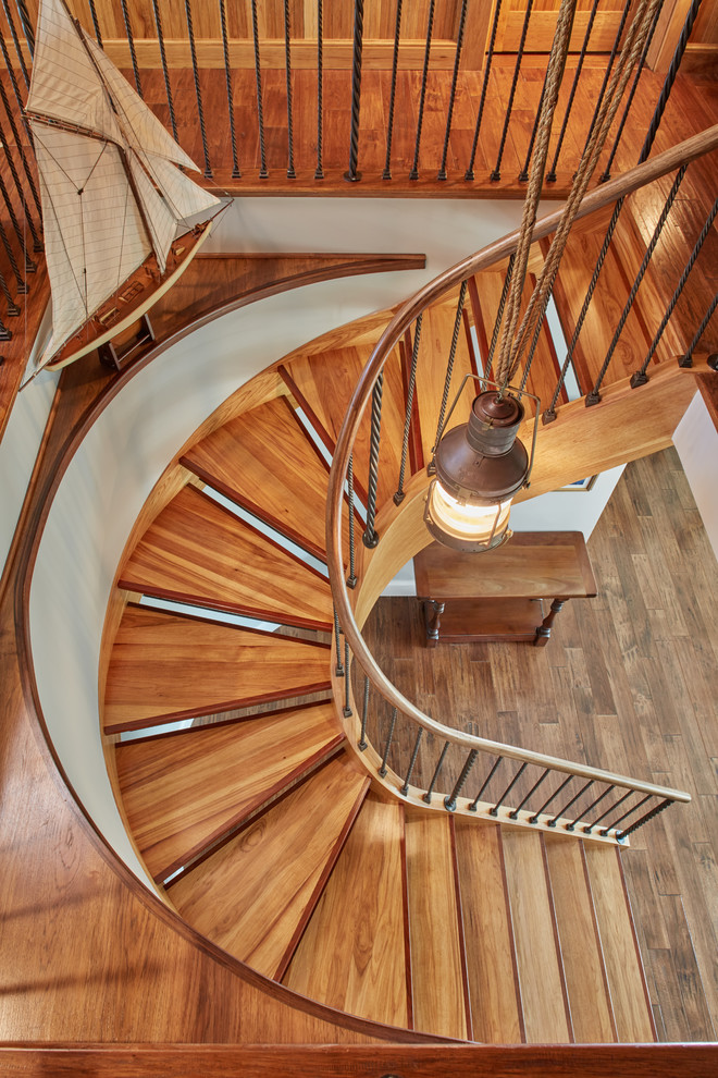 Inspiration for a small traditional wood spiral staircase in Baltimore with open risers.
