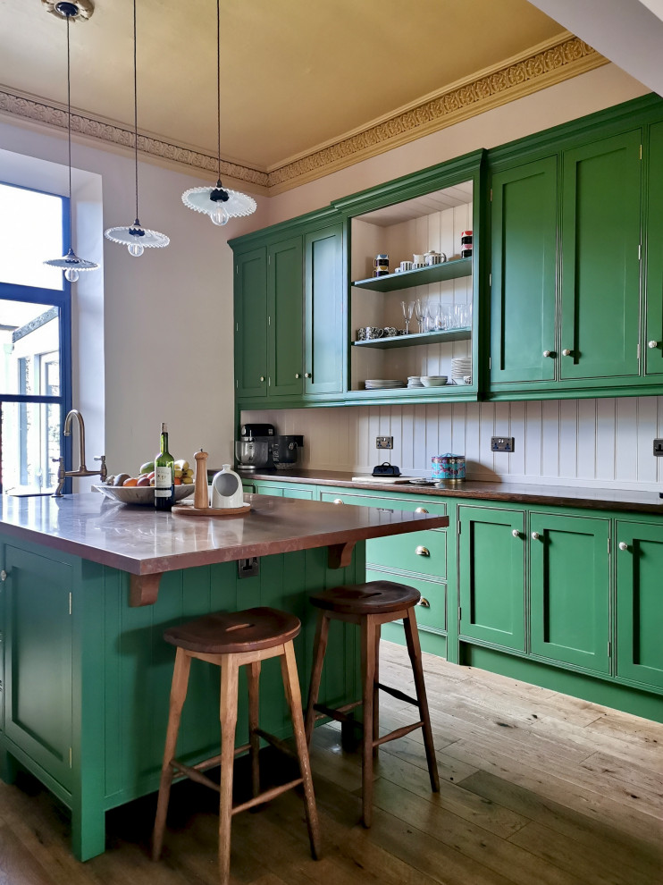 This is an example of a mid-sized transitional eat-in kitchen in Other with a farmhouse sink, shaker cabinets, green cabinets, wood benchtops, pink splashback, shiplap splashback, panelled appliances, medium hardwood floors, with island, brown floor and brown benchtop.