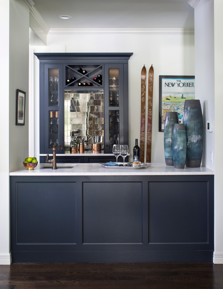 Mid-sized transitional home bar in Denver with an undermount sink, recessed-panel cabinets, blue cabinets, mirror splashback and dark hardwood floors.
