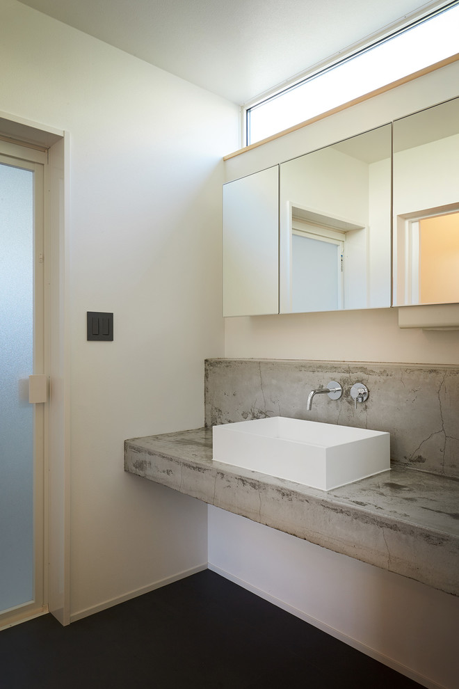 Contemporary powder room in Other with white walls, vinyl floors, a drop-in sink, concrete benchtops, grey floor and grey benchtops.