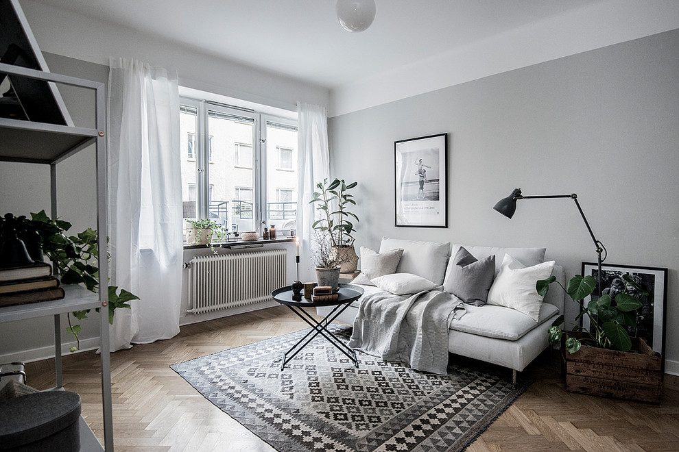 Photo of a mid-sized scandinavian enclosed living room in Stockholm with grey walls.