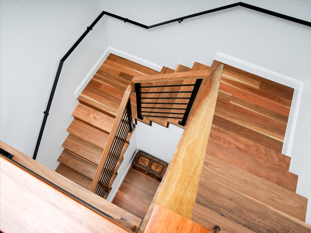 Inspiration for a mid-sized beach style wood u-shaped staircase in Brisbane with wood risers and mixed railing.