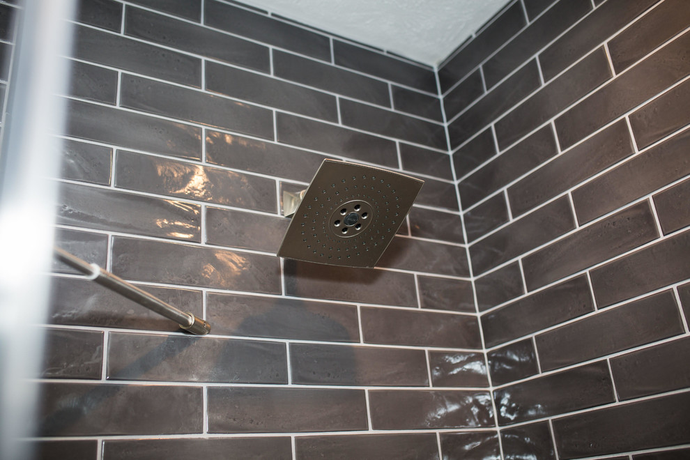 Inspiration for a mid-sized contemporary 3/4 black tile and subway tile porcelain tile and beige floor alcove shower remodel in Omaha with black cabinets, gray walls, an undermount sink, marble countertops and a hinged shower door