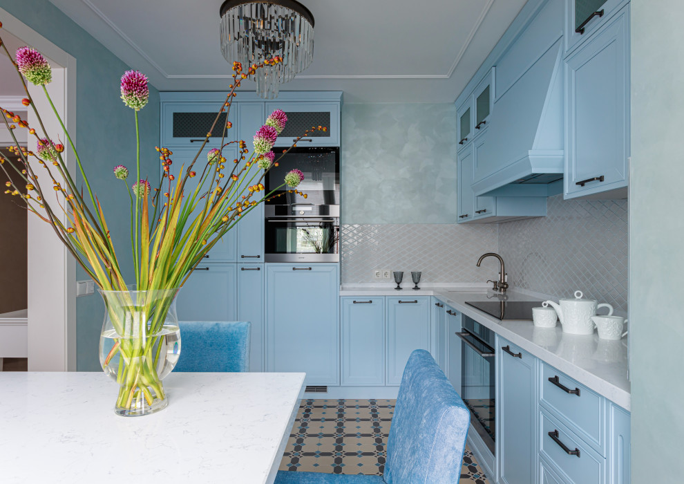 Small transitional l-shaped separate kitchen in Moscow with an undermount sink, raised-panel cabinets, turquoise cabinets, quartz benchtops, white splashback, ceramic splashback, stainless steel appliances, porcelain floors, no island, multi-coloured floor and white benchtop.