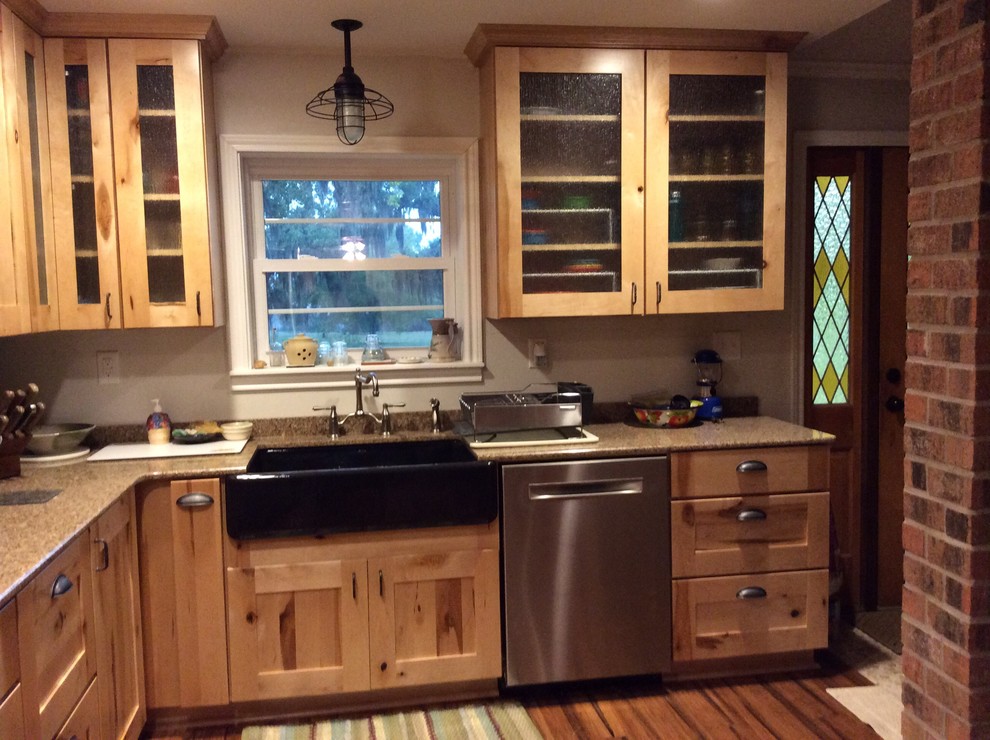 Enclosed kitchen - mid-sized rustic u-shaped medium tone wood floor enclosed kitchen idea in Houston with no island, recessed-panel cabinets, light wood cabinets, quartzite countertops, paneled appliances and a farmhouse sink