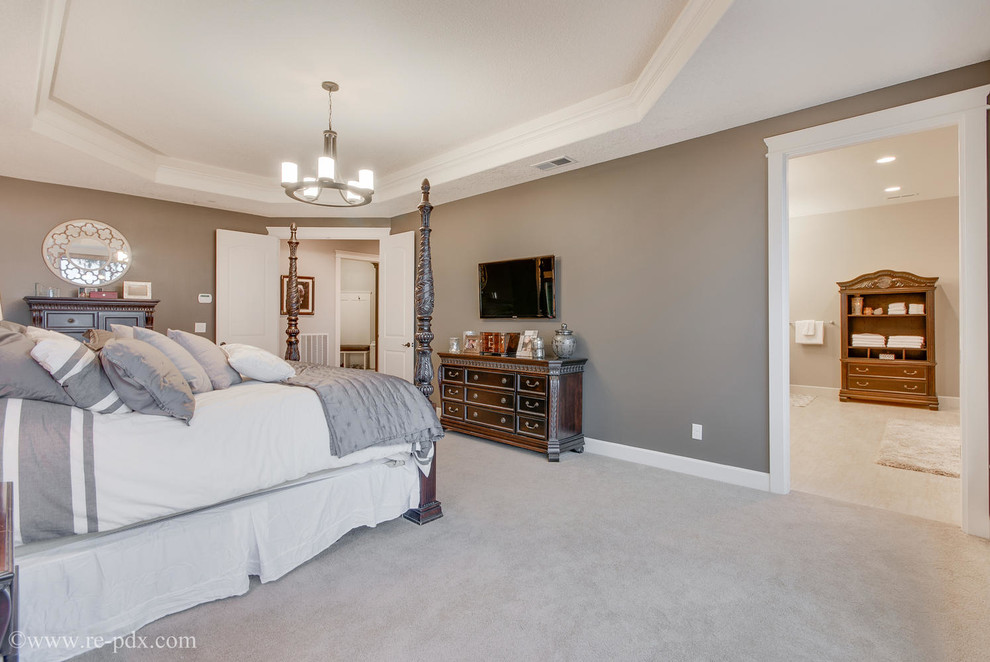 Large arts and crafts master bedroom in Portland with brown walls and carpet.