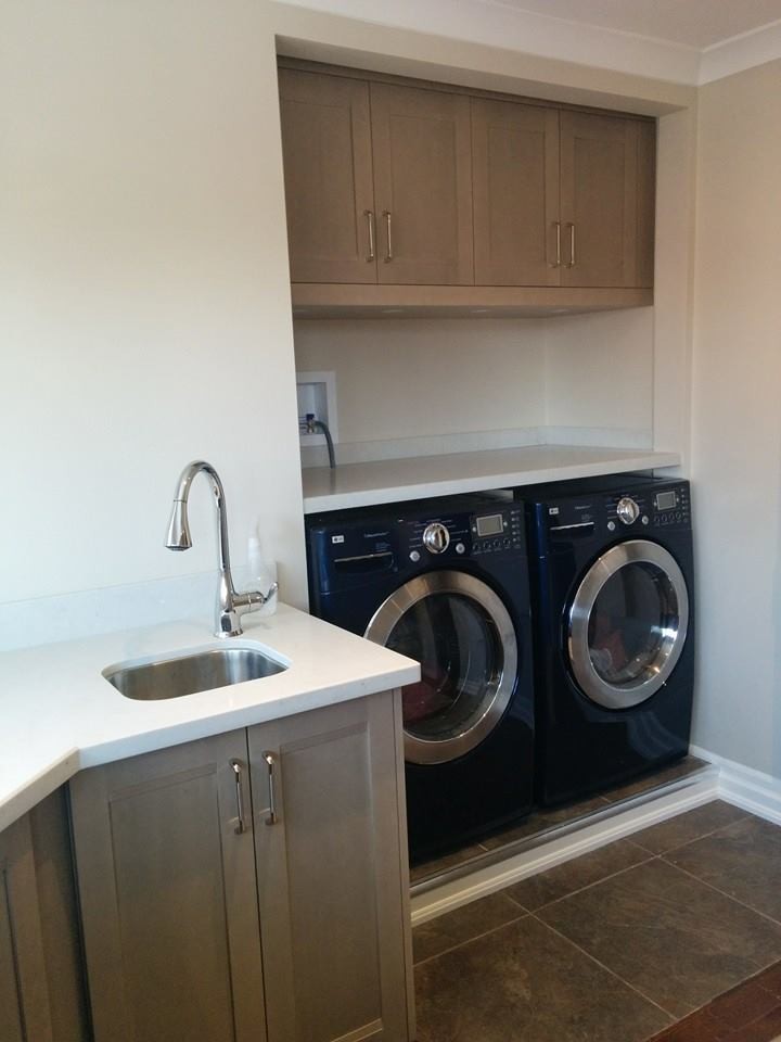 Example of a large transitional u-shaped slate floor dedicated laundry room design in Toronto with an undermount sink, shaker cabinets, gray cabinets, limestone countertops, beige walls and a side-by-side washer/dryer