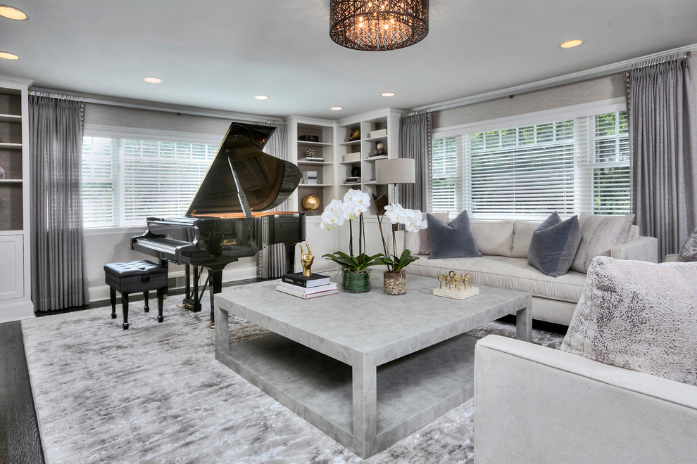 This is an example of a large transitional enclosed living room in New York with a music area, grey walls, dark hardwood floors, a standard fireplace, a brick fireplace surround, no tv and grey floor.