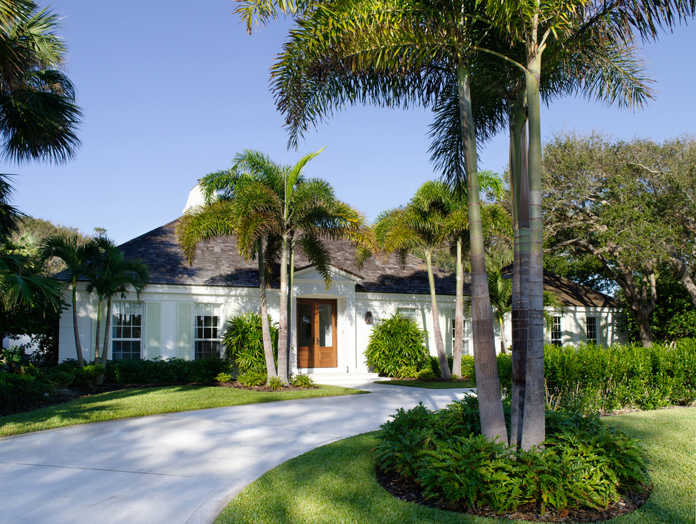 Photo of a tropical one-storey exterior in Miami with a hip roof.