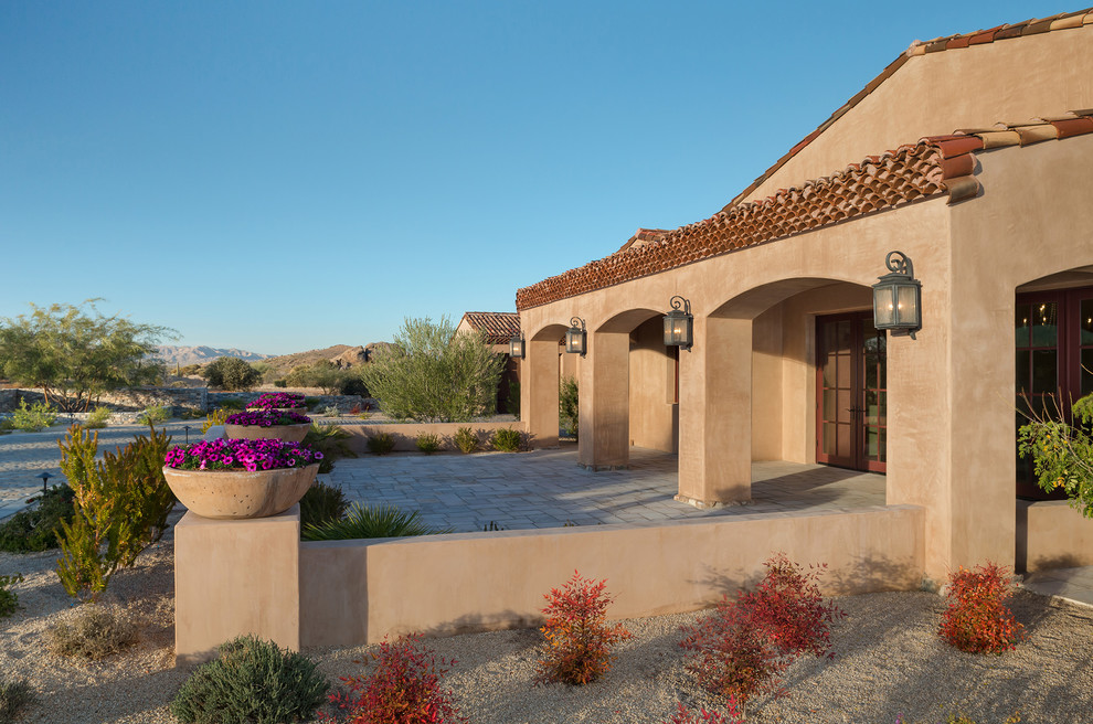 Inspiration for an expansive mediterranean one-storey stucco brown house exterior in Phoenix with a hip roof and a tile roof.