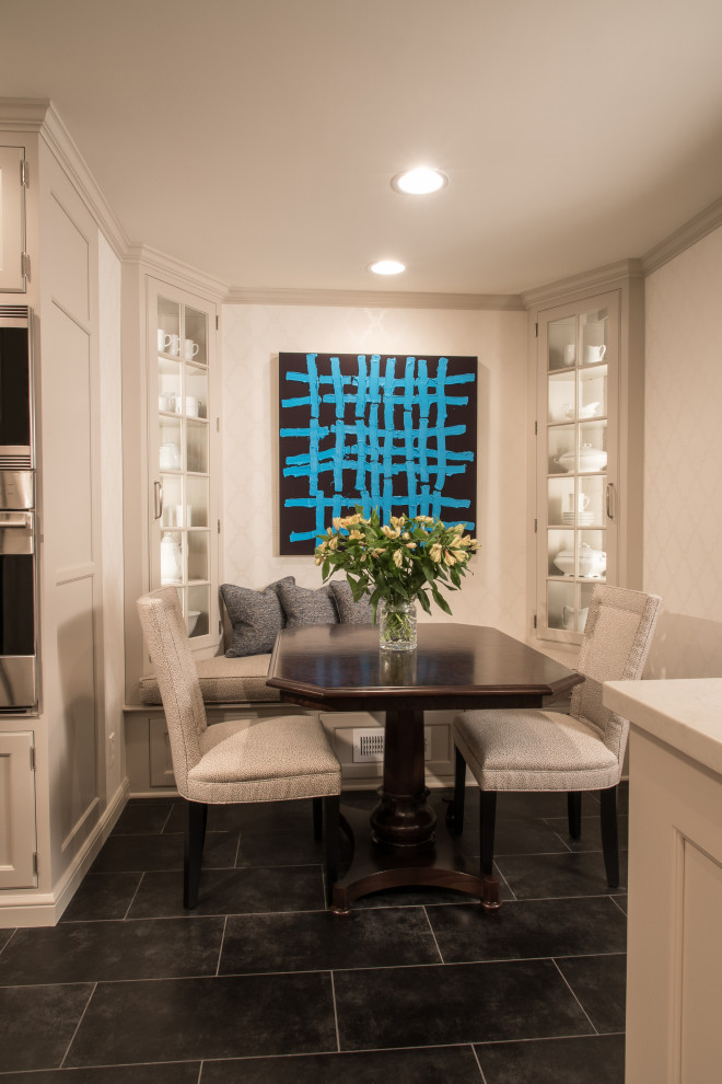 Example of a small transitional ceramic tile and black floor eat-in kitchen design with an undermount sink, beaded inset cabinets, gray cabinets, white backsplash, stainless steel appliances and white countertops