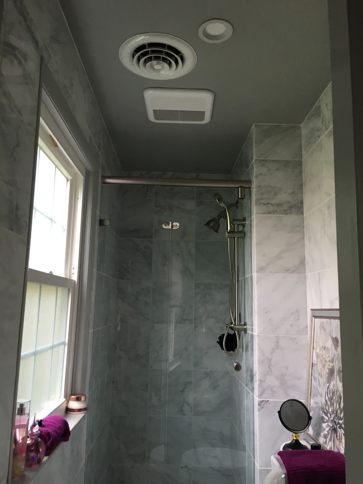 This is an example of a small contemporary 3/4 bathroom in Philadelphia with an alcove shower, a two-piece toilet, white tile, stone tile and marble floors.
